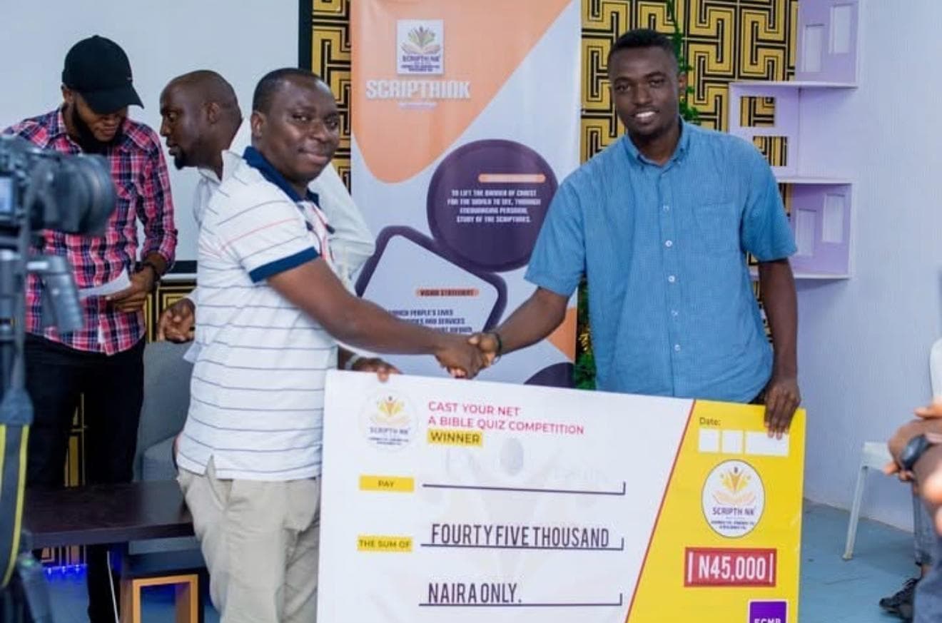 A previous Cast Your Net Bible Quiz winner receiving a prize cheque